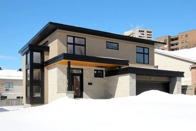 Inspiration for a large modern beige two-story stone flat roof remodel in Ottawa