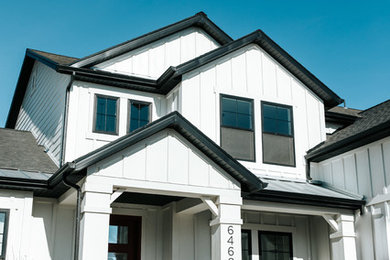 Country white two-story townhouse exterior idea in Salt Lake City with a mixed material roof
