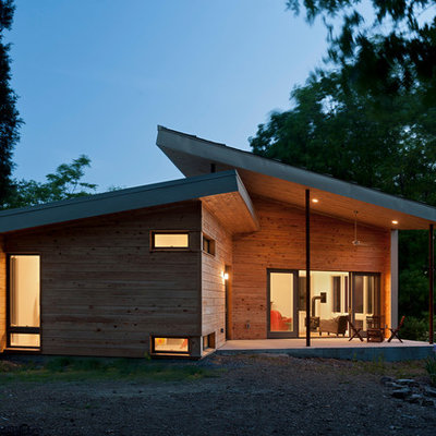 Example of a small trendy brown one-story wood house exterior design in DC Metro with a shed roof and a metal roof