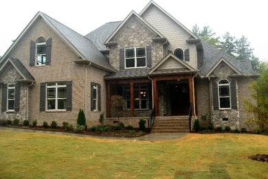 Large traditional gray two-story mixed siding exterior home idea in Other with a shingle roof