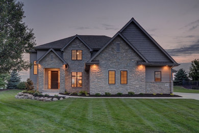 Inspiration for a large transitional gray two-story mixed siding exterior home remodel in Omaha with a shingle roof