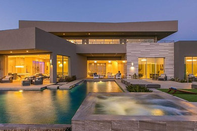Inspiration for a huge modern multicolored one-story stucco exterior home remodel in Las Vegas