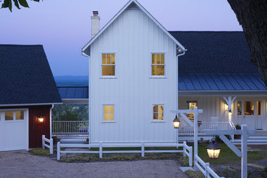 Réalisation d'une façade de maison blanche champêtre en bois à un étage.