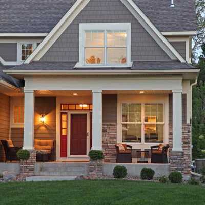 Example of a mid-sized classic gray two-story stone gable roof design in Minneapolis