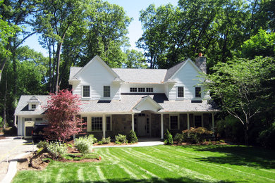 Ejemplo de fachada de casa blanca tradicional grande de dos plantas con revestimiento de madera, tejado a dos aguas y tejado de teja de madera