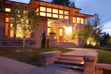 Example of a minimalist two-story stone exterior home design in Denver