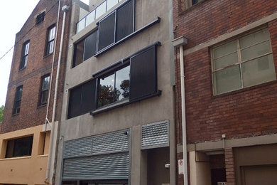 Modelo de fachada de piso gris contemporánea de tamaño medio de tres plantas con revestimiento de ladrillo y tejado de metal