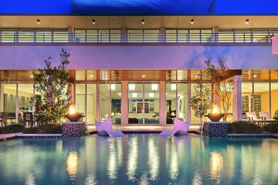 Inspiration for a contemporary white stucco exterior home remodel in Miami