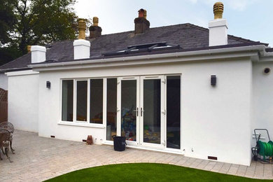 Medium sized and white modern house exterior in Devon with mixed cladding.