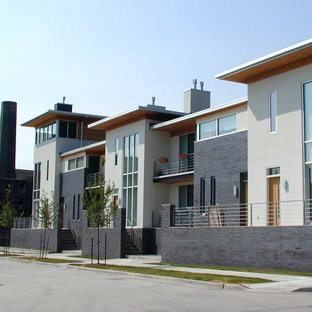 Large modern multicolored three-story mixed siding exterior home idea in Milwaukee