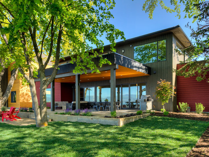 Large modern brown two-story mixed siding exterior home idea with a shingle roof