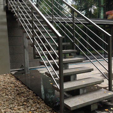 Riverview Drive privet house exterior metal and stone staircase