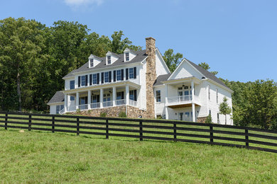 Example of a large farmhouse white two-story mixed siding exterior home design in Other with a shingle roof