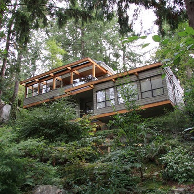 Mid-sized trendy green two-story wood house exterior photo in Vancouver with a mixed material roof