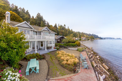 Large beach style gray two-story wood exterior home photo in Seattle