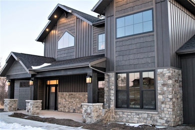 Large mountain style brown two-story concrete fiberboard exterior home photo in Other with a shingle roof