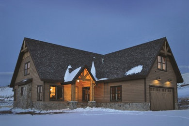 Aménagement d'une grande façade de maison marron montagne à un étage avec un revêtement mixte et un toit à croupette.