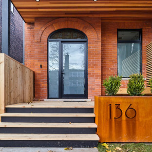 Ejemplo de fachada de casa roja, contemporánea, de tamaño medio, de dos plantas, con revestimientos combinados, tejado a dos aguas y tejado de teja de madera