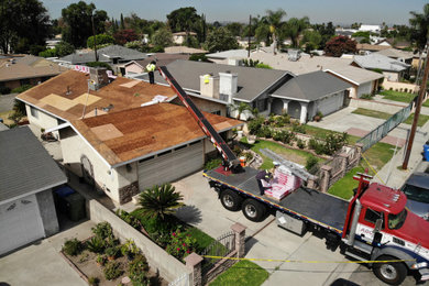 Inspiration for a mid-sized one-story stucco gable roof remodel in Los Angeles