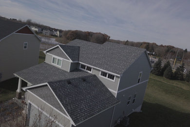 Mid-sized transitional gray three-story vinyl exterior home photo in Minneapolis with a shingle roof