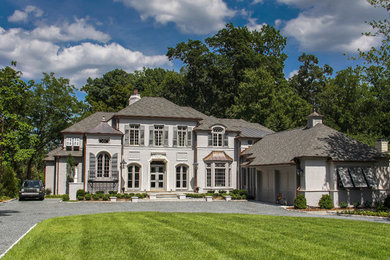 Geräumiges, Zweistöckiges Eklektisches Haus mit Putzfassade, beiger Fassadenfarbe und Satteldach in Charlotte