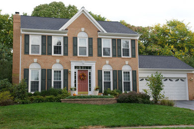 Mid-sized elegant brown two-story brick exterior home photo in DC Metro with a tile roof