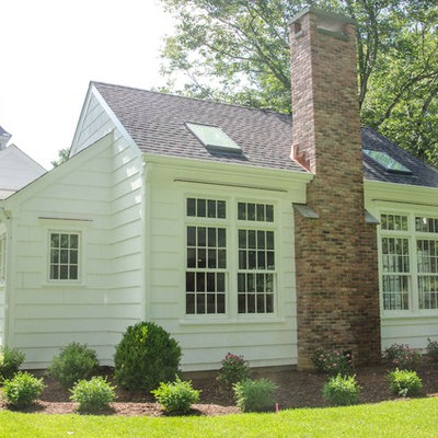Large traditional white one-story wood exterior home idea in New York with a shingle roof