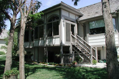 Large traditional gray two-story vinyl exterior home idea in Wichita