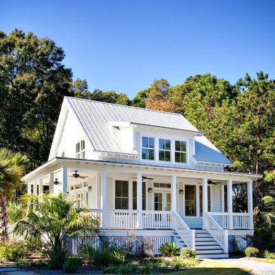 Example of a small classic white two-story concrete fiberboard exterior home design in Charleston with a metal roof