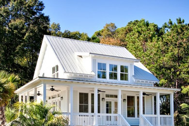 Example of a small classic white two-story concrete fiberboard exterior home design in Charleston with a metal roof