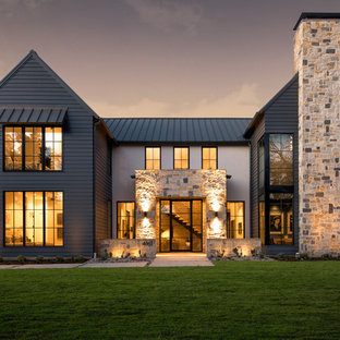 Country multicolored two-story mixed siding exterior home photo in Dallas with a metal roof