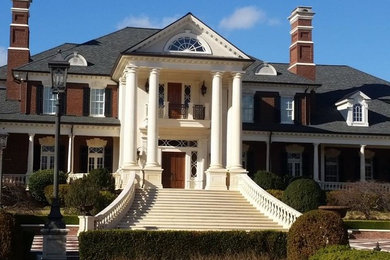 Inspiration for a huge victorian three-story brick exterior home remodel in Atlanta with a mixed material roof