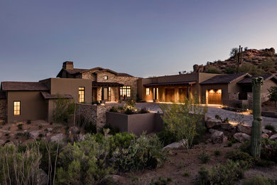 Inspiration for a southwestern brown one-story mixed siding exterior home remodel in Phoenix with a mixed material roof