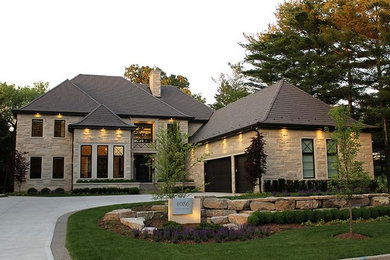 Example of a huge classic beige two-story stone house exterior design in Toronto with a hip roof and a shingle roof