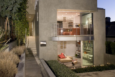 Modern three-story concrete exterior home idea in Los Angeles