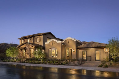 Inspiration for a large mediterranean two-story house exterior remodel in Phoenix