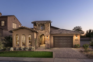Example of a tuscan beige exterior home design in Phoenix