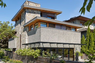 Exemple d'une façade de maison grise tendance de taille moyenne et à deux étages et plus avec un revêtement mixte et un toit plat.