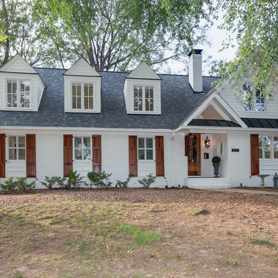 Mid-sized transitional white two-story brick exterior home idea in Raleigh with a shingle roof