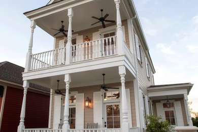Mid-sized traditional beige three-story vinyl gable roof idea in New Orleans