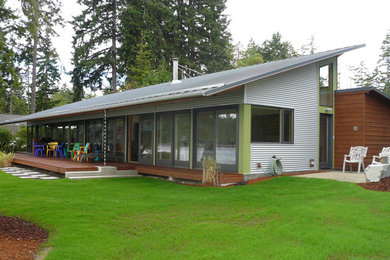 This is an example of a medium sized contemporary bungalow house exterior in Seattle with wood cladding.