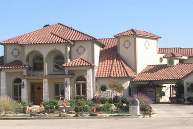 Huge tuscan beige two-story mixed siding exterior home photo in Dallas