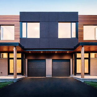 Esempio della facciata di una casa bifamiliare contemporanea con rivestimento in legno
