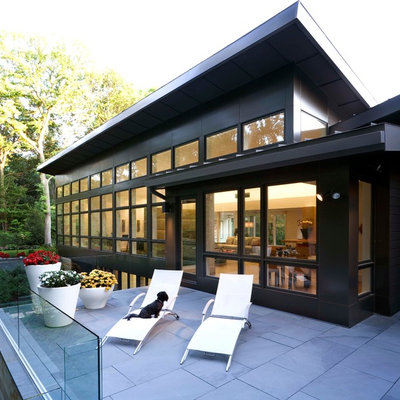 Trendy black two-story exterior home photo in Detroit with a shed roof