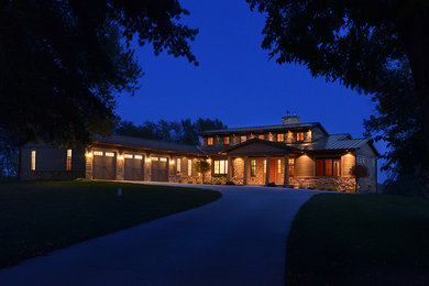 Large and brown bungalow house exterior in Cedar Rapids with stone cladding and a pitched roof.