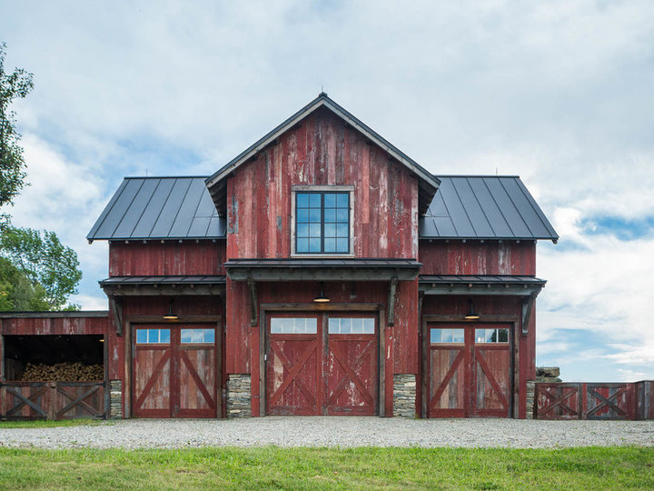 Medium-sized red, two-story, wood-outside home with a metal roof.