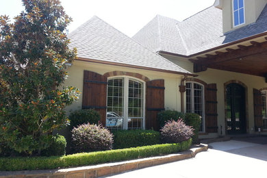 Inspiration for a mid-sized craftsman beige two-story mixed siding house exterior remodel in Dallas with a hip roof and a shingle roof
