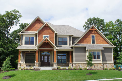 Large elegant brown two-story mixed siding house exterior photo in Indianapolis with a shingle roof