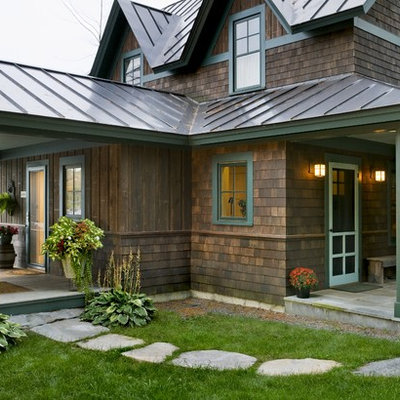 Inspiration for a rustic two-story wood exterior home remodel in Burlington with a metal roof