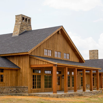 Example of a farmhouse wood exterior home design in New Orleans